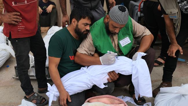 A dead child’s shroud is identified in Deir Balah. Picture: AFP