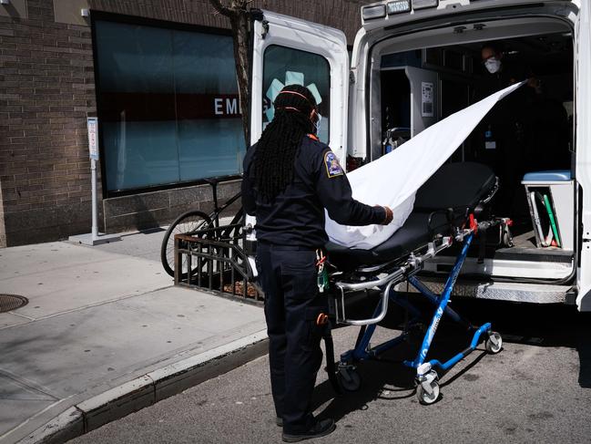 Ambulance workers clean a gurney at Mount Sinai Hospital in New York City, the epicentre of the outbreak in the US. Picture: Getty