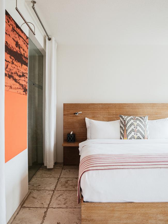 A whitewashed room with ikat pillows by Rifat Ozbek. Picture: Elise Hassey