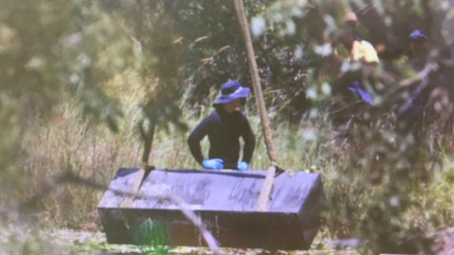 Police retrieve the toolbox from the dam.