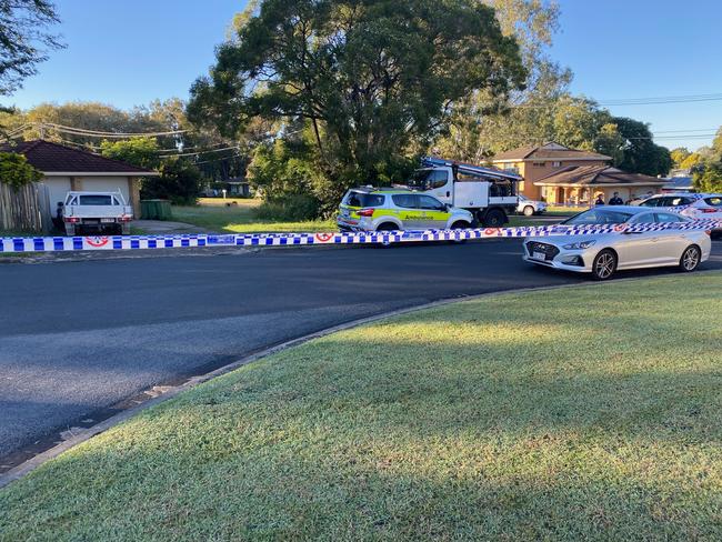 Police have cordoned off Mahogany St at Raceview following a house fire and disturbance early Friday morning in which a man was seriously injured.