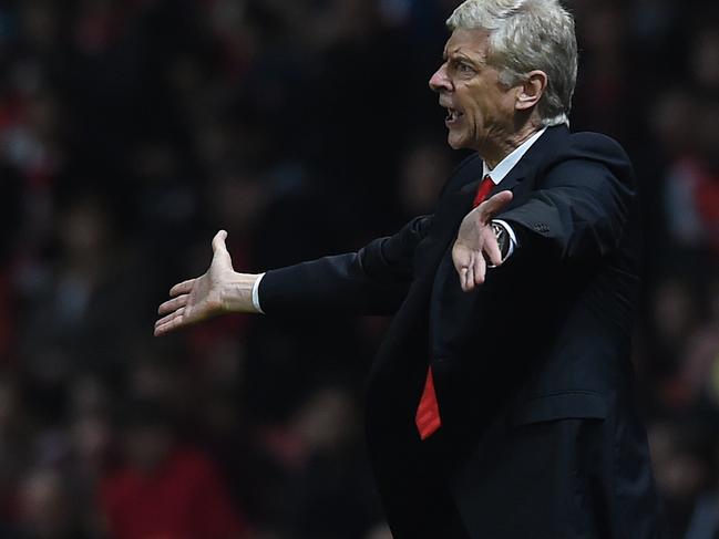 Arsenal’s manager Arsene Wenger shouts across the pitch during the English Premier League soccer match between Arsenal and Manchester United at the Emirates Stadium, London, Saturday, Nov. 22, 2014. (AP Photo/Tim Ireland)