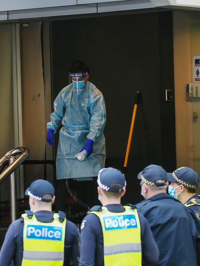 A worker disinfects the steps at the Hotel Grand Chancellor in Lonsdale St during the height of the hotel quarantine crisis. Picture: Ian Currie