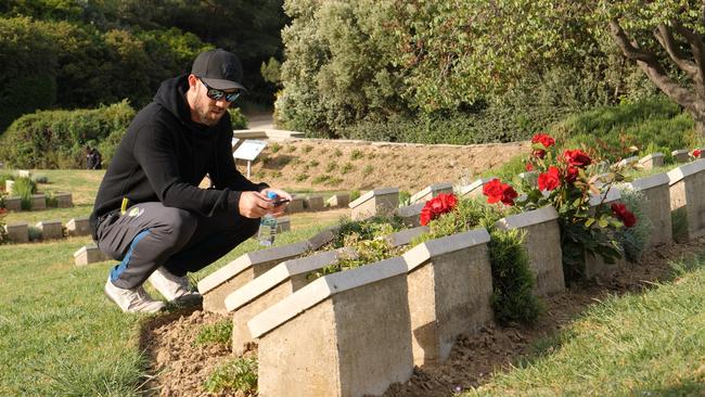 Glenn Maxwell takes a quiet moment to remember the fallen.