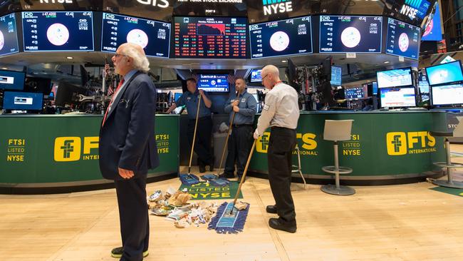 Personal sweep the floor after the closing bell of the Dow Industrial Average at the New York Stock Exchange on February. Picture: AFP PHOTO.