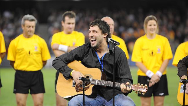 Russell Robertson singing the national anthem at the EJ Whitten Legends Game.