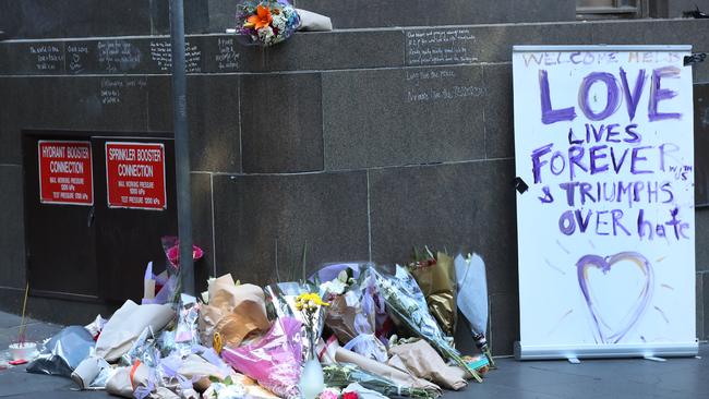 Flowers left at the scene of the attack in Bourke St. Picture: David Crosling