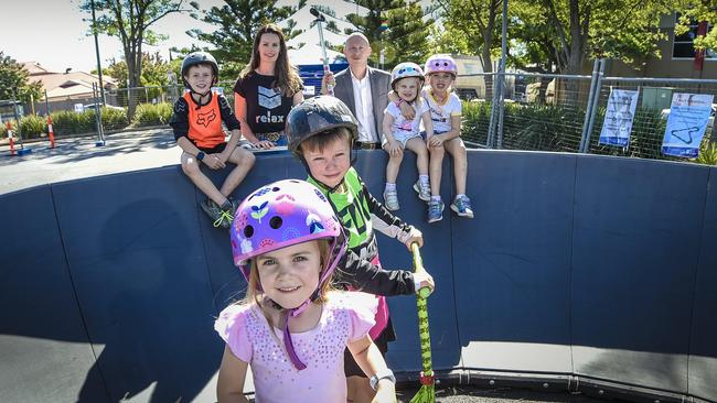 Richelle Martin and Chris Cowley (rear) with children playing on the pump track. Picture: AAP/Roy VanDerVegt