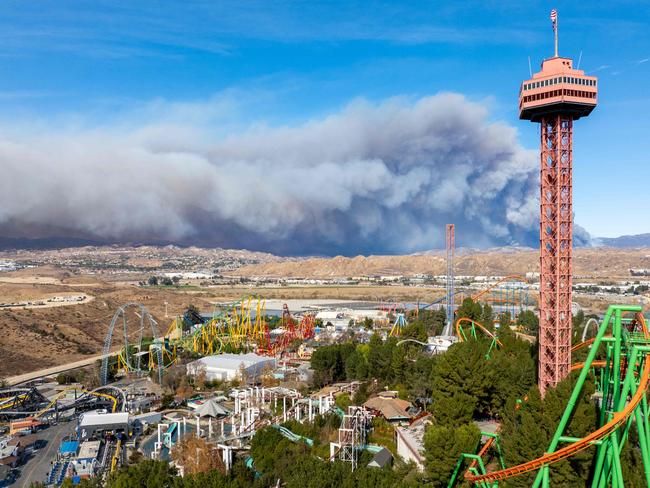 The Hughes fire burns behind the skyline of Six Flags Magic Mountain in Valencia, California. The wildfire is prompting mandatory evacuations just over two weeks after the Eaton and Palisades fires caused widespread destruction. Picture: Getty Images via AFP