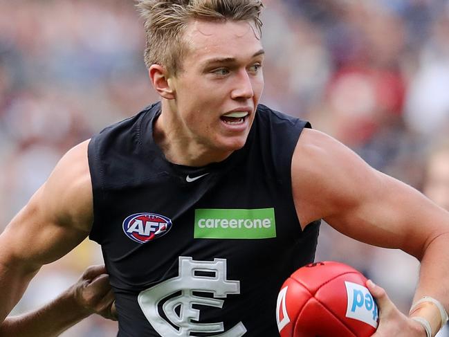 AFL Round 7. Collingwood v Carlton at the MCG. Patrick Cripps brushes past Adam Oxley . Pic: Michael Klein