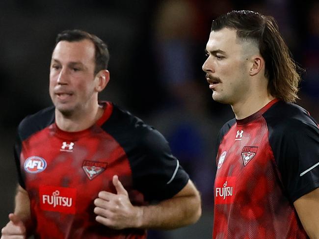 MELBOURNE, AUSTRALIA - APRIL 12: Todd Goldstein (left) and Sam Draper of the Bombers warm up during the 2024 AFL Round 05 match between the Western Bulldogs and the Essendon Bombers at Marvel Stadium on April 12, 2024 in Melbourne, Australia. (Photo by Michael Willson/AFL Photos via Getty Images)