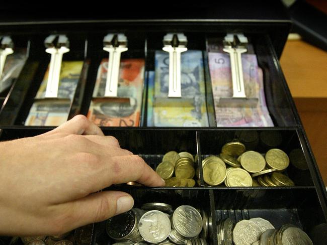 Generic photo of hand in money till cash register with coins and notes 21 Jul 2006.