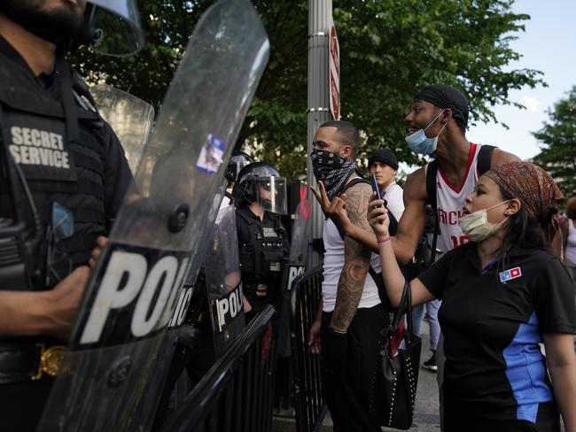 Demonstrators vent their anger at police in riot gear near the White House in Washington. Picture: Evan Vucci