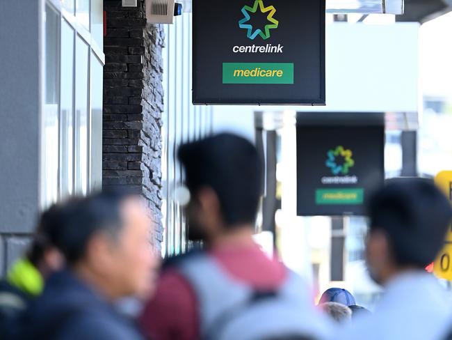 MELBOURNE, AUSTRALIA - MARCH 24: Peopler queue to enter Centrelink on March 24, 2020 in Melbourne, Australia. Non-essential travel has been banned in a bid to stop the spread of COVID-19 in Australia while venues such as bars, clubs, nightclubs, cinemas, gyms and restaurants, along with anywhere people remain static are now closed. Schools are currently open but parents have the option to keep children at home if they wish. There are now 1887 confirmed cases of COVID-19 in Australia and the death toll now stands at eight. (Photo by Quinn Rooney/Getty Images)