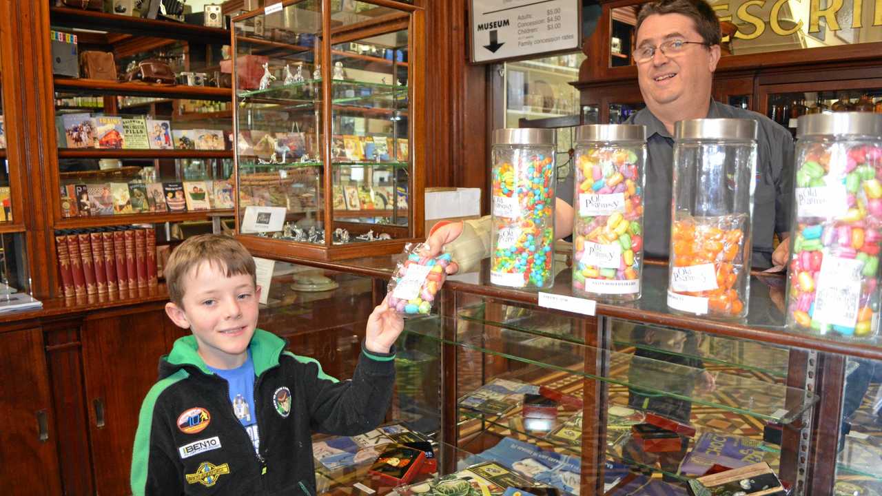 Liam Seery tries some of the sweet treats on sale with Scott Stedman at the Old Pharmacy in Churchill St, Childers. Picture: Brittany Cook