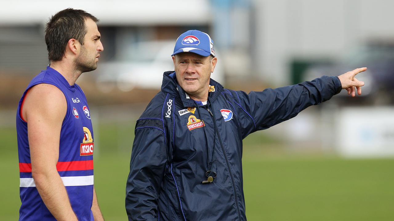 Rodney Eade points Brian Lake in the direction of the extra running group after training.