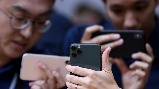 Attendees look at the new Apple iPhone 11 Pro during an Apple special event in Cupertino, California last month. Picture: Getty Images