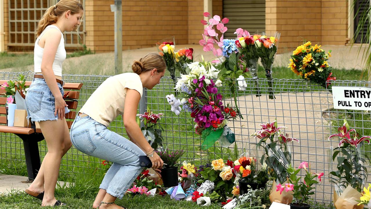 Local residents lay flowers at the Tara Police station where Constable Rachel McCrow, 29, and Constable Matthew Arnold, 26 worked. Picture: NCA NewsWire/ David Clark