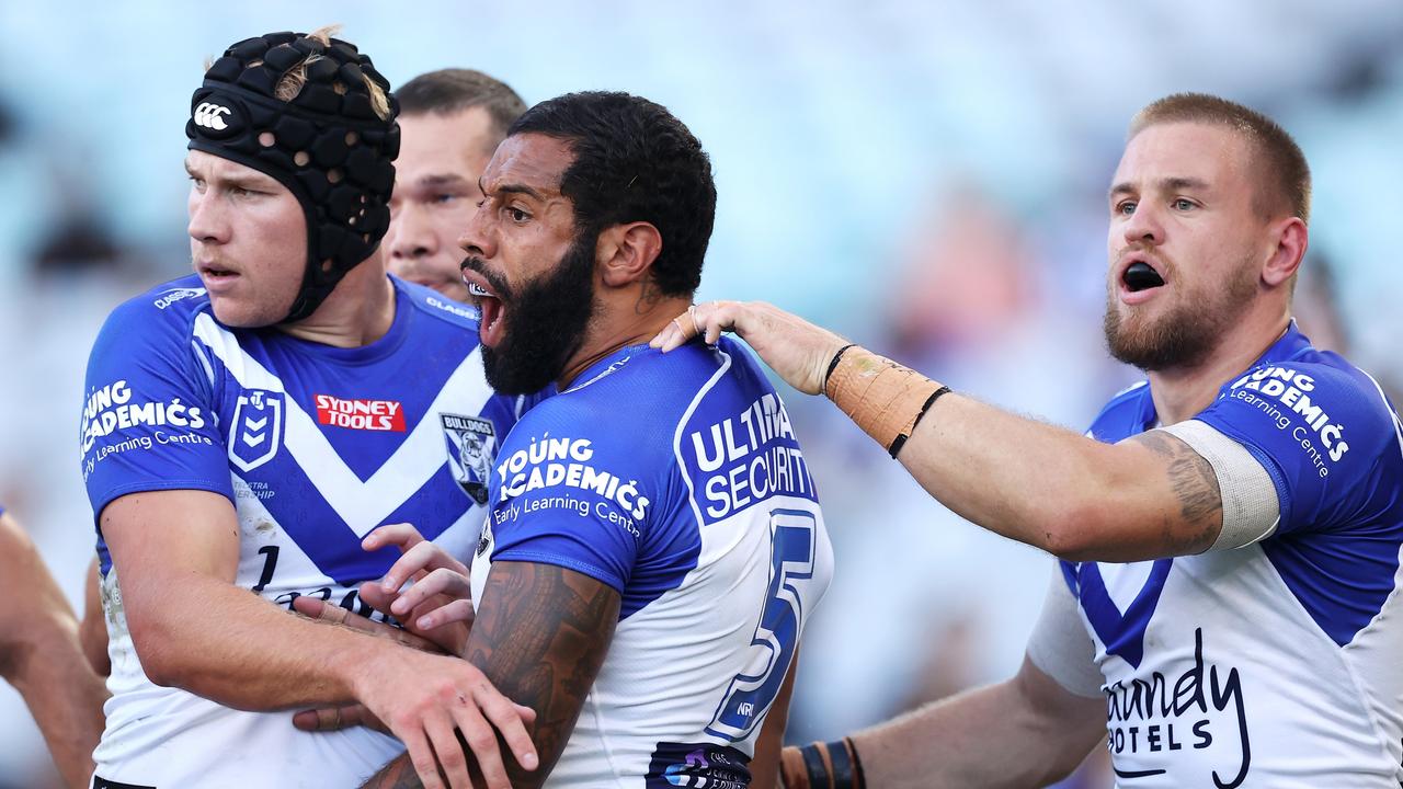 SYDNEY, AUSTRALIA - MARCH 20: Matt Burton, Josh Addo-Carr and Matt Dufty of the Bulldogs celebrate a defensive effort during the round two NRL match between the Canterbury Bulldogs and the Brisbane Broncos at Accor Stadium, on March 20, 2022, in Sydney, Australia. (Photo by Mark Kolbe/Getty Images)