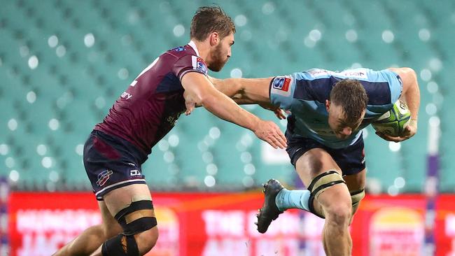 Jack Dempsey avoiding a tackle by Josh Flook at an empty SCG in August.