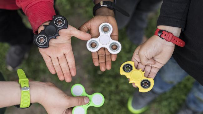 Children hold fidget spinners. Picture: Alessandro della Valle/Keystone via AP