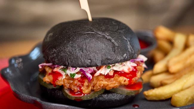 In the Das Steakhouse, you can get the “Blood” Orange Chicken Sandwich – a flash-fried marinated chicken breast tossed in a tantalising blood orange sauce served in a sinister black bun with tangy pickles, a slaw and crispy fries. Photo: Universal Epic Universe