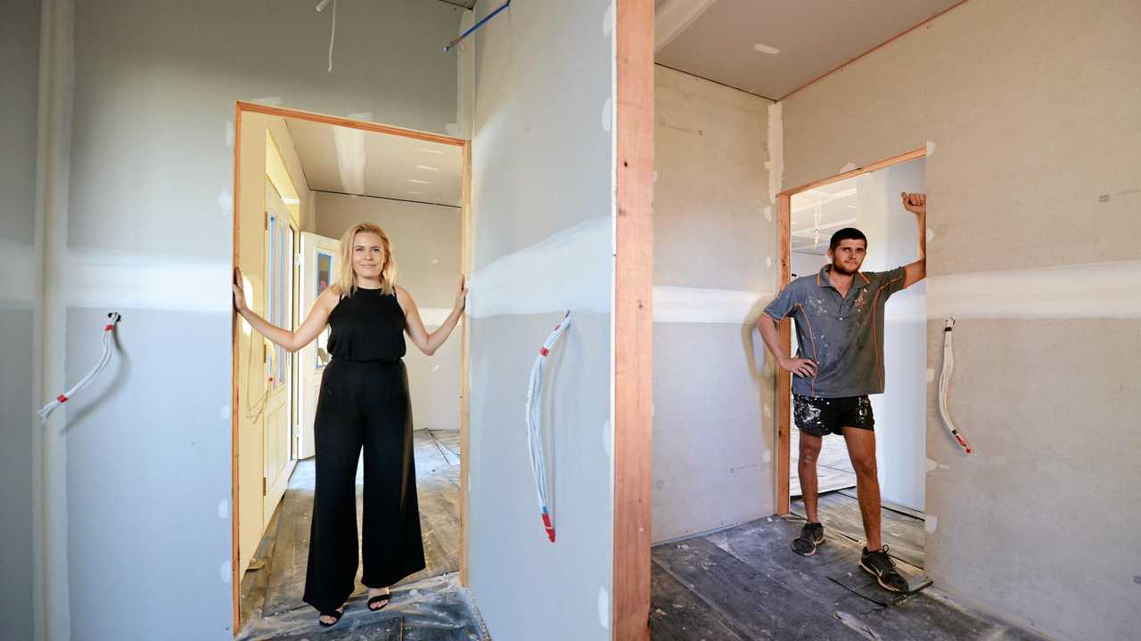 Mackay house-flippers Madison Strutynski and Michael Cotter at their Hunter St, West Mackay property. Picture: Stuart Quinn