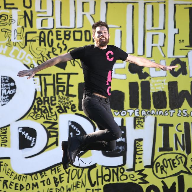 Campbelltown Arts Centre creative learning officer Timothy George in front of the eye-catching mural. Picture: Robert Pozo