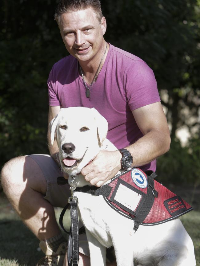 Ex Australian Army infantryman, Andrew Glebow is delighted with his new "Assistance Dog" Leon in his back yard in Shailer Park, Brisbane.