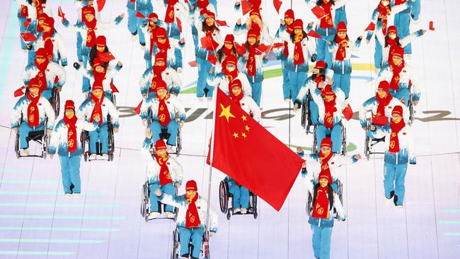 Flag bearers Yujie Guo and Zhidong Wang of Team China lead their team out during the Opening Ceremony of the Beijing 2022 Winter Paralympics. Picture: Getty