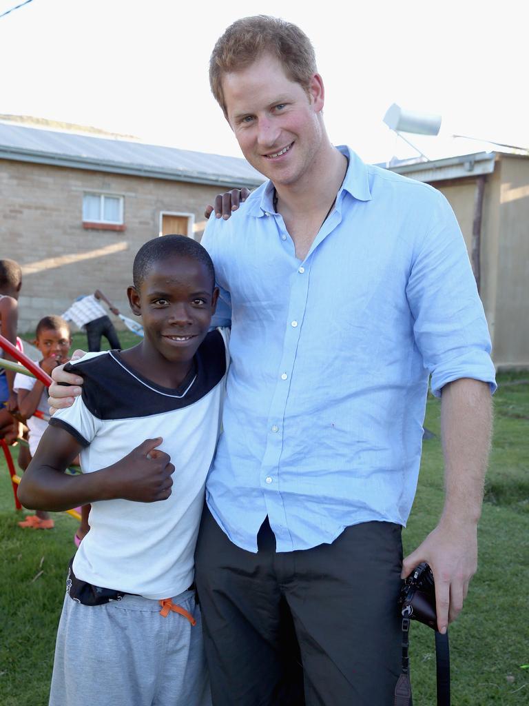 Prince Harry hugs a young boy called Mutso during a visit to the Mants’ase Children’s Home on December 5, 2014 in Mohales Hoek. Picture: Getty