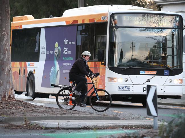 Merging bike lanes at Bridge and Evans streets Port Melbourne. An elderly cyclist tries to negotiate the cross over from the middle bike lane and the round-a-bout with a bus that stopped for him.                      Picture: David Caird