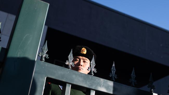 A Chinese paramilitary policeman stands guard at the Australian embassy in Beijing. Picture: AFP.