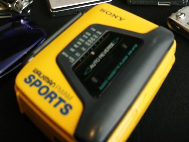 HERALD SUN Andrew Hughes and his collection of Sony Walkmans dating back to the 70's. The oldest one from the seventies is in his hand and the latest ones are in his ears ( the music hub is in the ear buds).