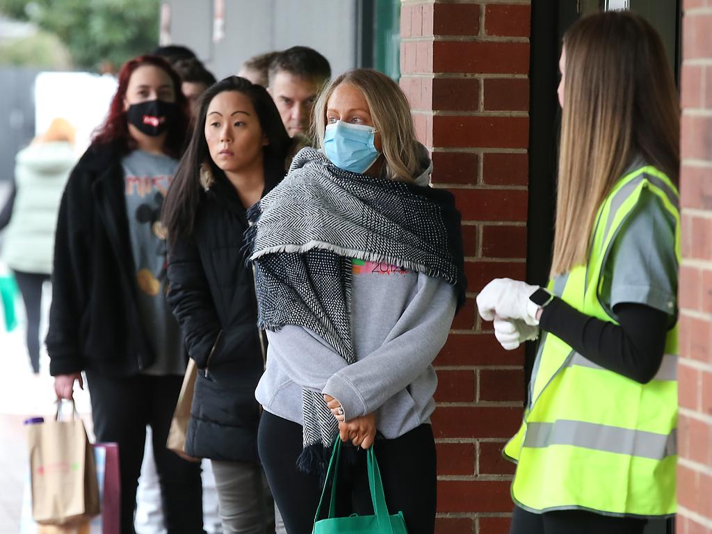 People queue outside a Melbourne supermarket to stock up on the essentials. Picture: NCA NewsWire/Ian Currie.