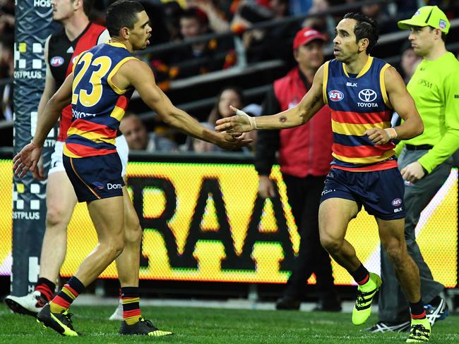 Adelaide Crows Eddie Betts celebrates kicking a goal with teammate Charlie Cameron.