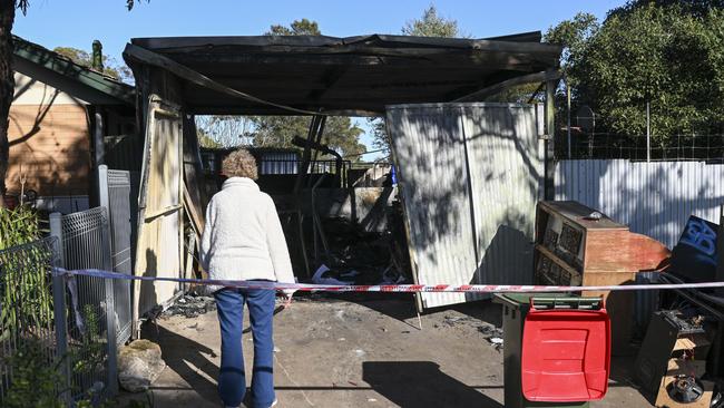 Denise Thompson who was staying at the property surveys what’s left of the shed that caught fire. Picture: Mark Brake