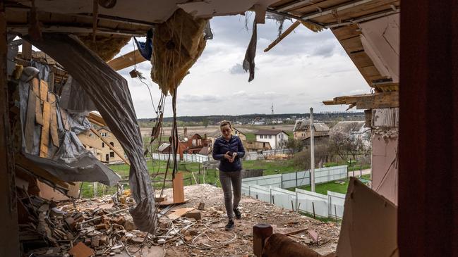 Oksana walks through the destroyed second floor of her multi-generational home while searching for salvageable items in Hostomel, Ukraine. Picture: Getty Images