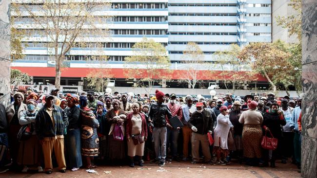 Informal vendors gather in front of a municipal office building in Braamfontein, Johannesburg, as they try to obtain a permit for working during the 21 days national lockdown that started on March 27.