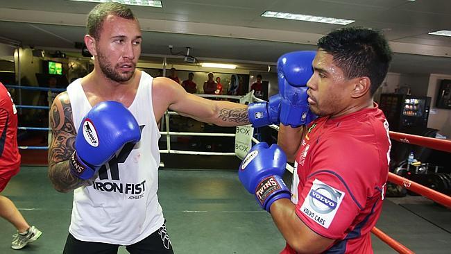 Quade Cooper spars with Reds teammate Ben Tapuai last year. Picture: Annette Dew