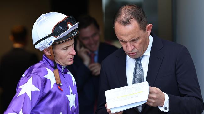 Trainer Chris Waller (right) speaks with jockey James McDonald ahead of a race at Rosehill. Picture: Jeremy Ng / Getty Images