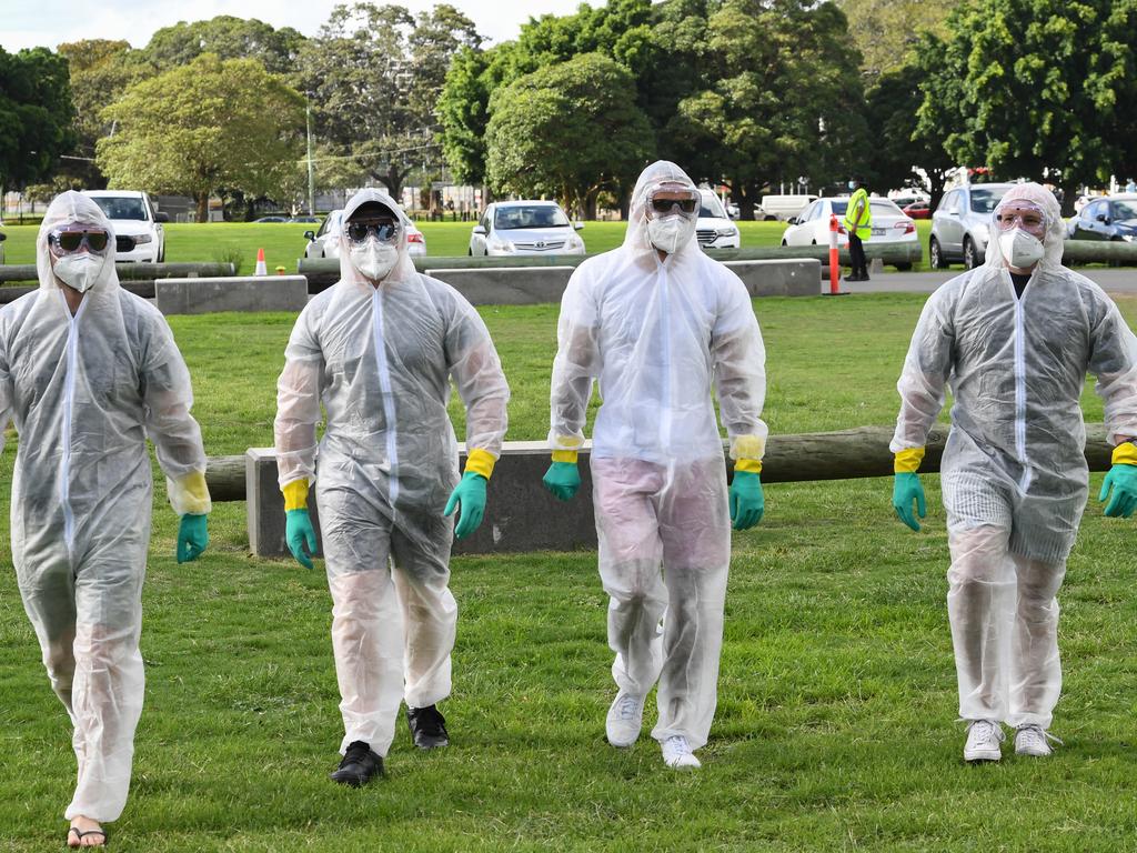 Four cricket fans dress up in full protective suits as they arrive at the Sydney Cricket Ground.