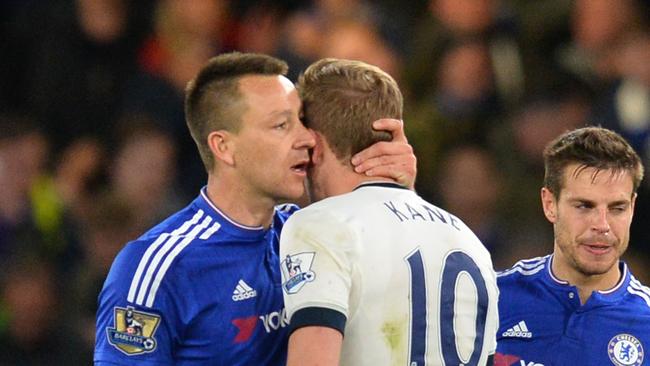 John Terry (L) shares a word with Harry Kane (C).