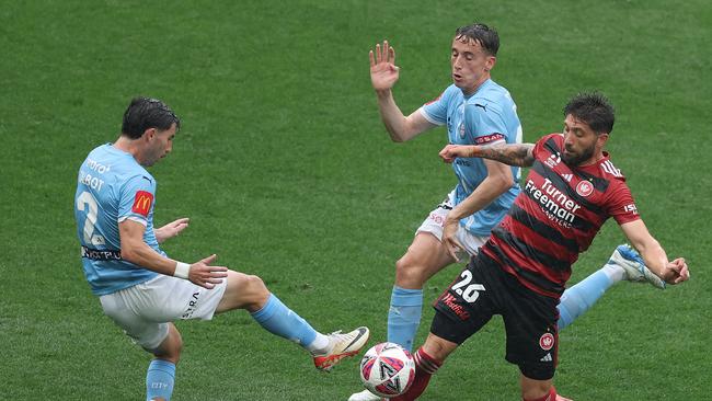 MELBOURNE, AUSTRALIA - NOVEMBER 30: Brandon Borrello of Western Sydney Wanderers is challenged by Kai Trewin and Callum Talbot of Melbourne Cityduring the round six A-League Men match between Melbourne City and Western Sydney Wanderers at AAMI Park, on November 30, 2024, in Melbourne, Australia. (Photo by Robert Cianflone/Getty Images)