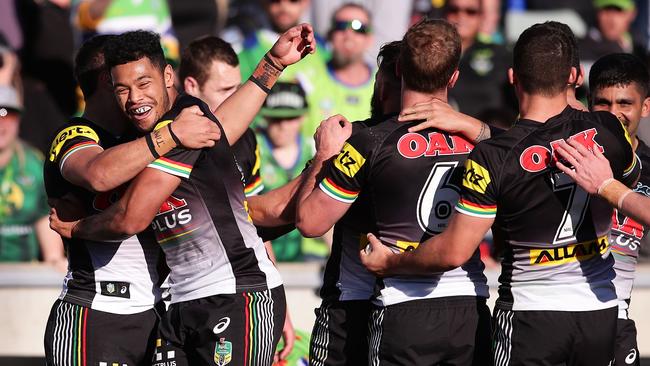 Panthers players celebrate victory over the Raiders at GIO Stadium.