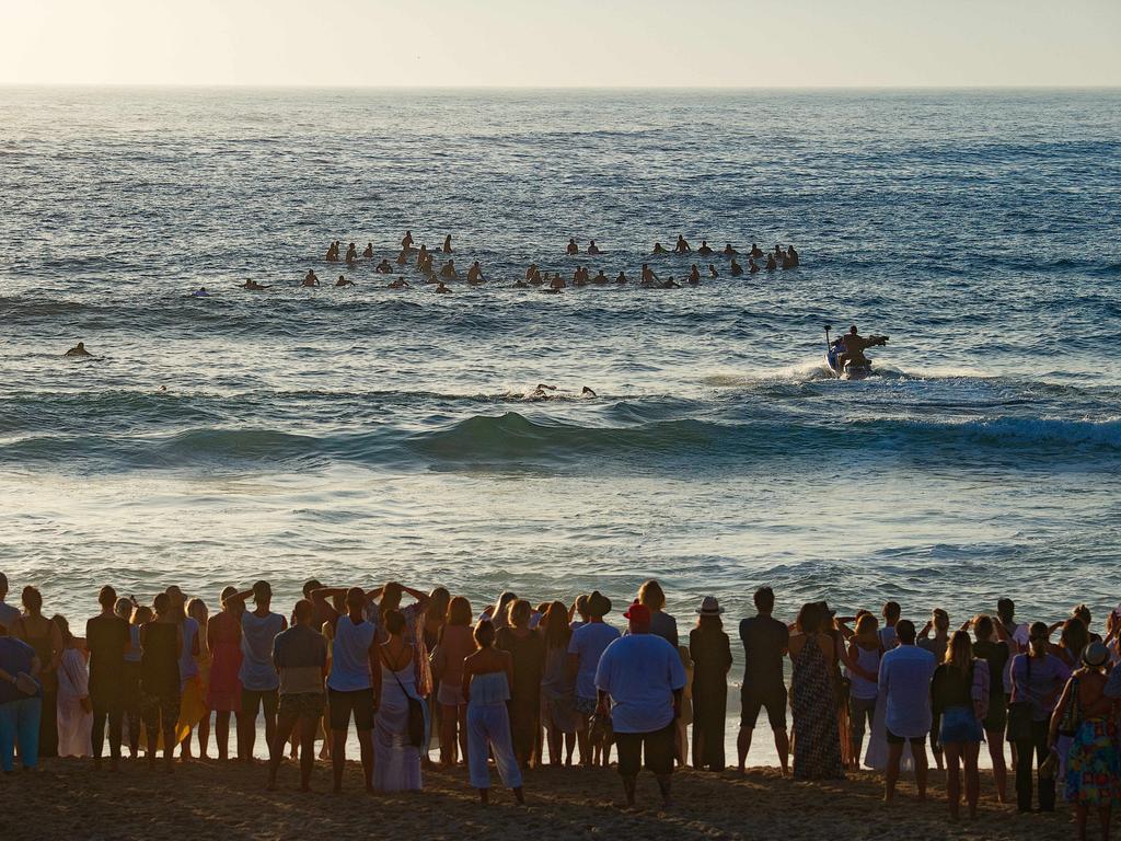 Surfers making there way out to sea to pay tribute to Annalise Braakensiek at the Memorial held at Bondi Beach around 7am Wednesday January 16 Image Picture: Monique Harmer