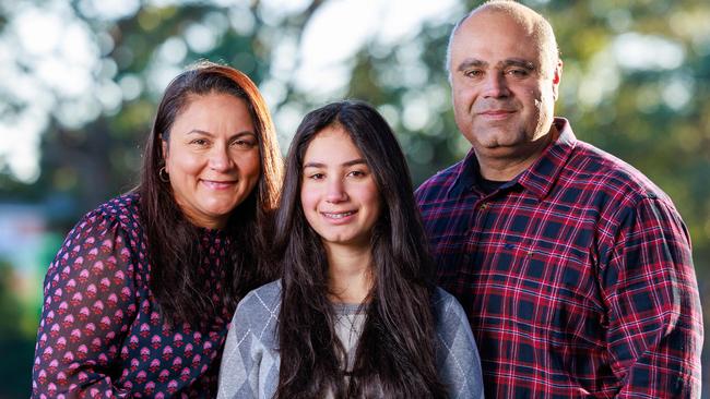 Daily Telegraph. 23, May, 2024.Dany and Cynthia Elachi, with their daughter Aalia, 14, at home, in Bexley, Sydney, today. Aalia is not allowed social media or a phone. Picture: Justin Lloyd.