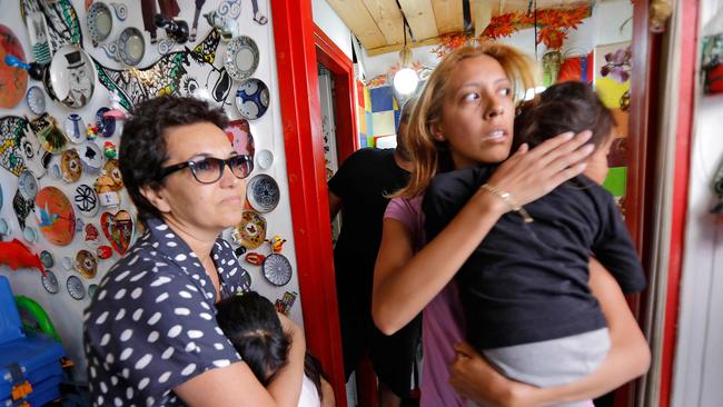 Israelis take cover in a shop as a siren rings during an attack of rockets from the Hamas-controlled Gaza Strip into Israel, on May 13 Picture: Gil Cohen-Magen/AFP