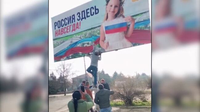 Watch: Russian billboard is torn down near Kherson