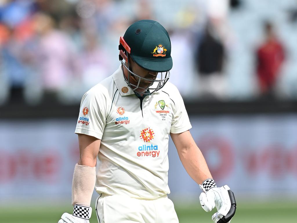 Travis Head of Australia walks off the field after being dismissed by Mohammed Siraj.